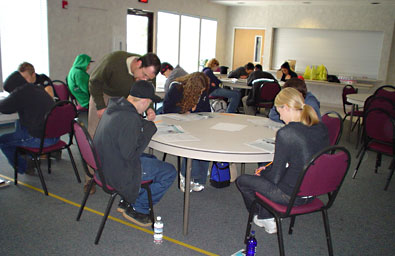Kids sitting at tables studying Kids sitting at tables studying